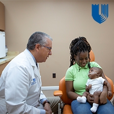 Dr. Pedro Santiago meets with a mom and her baby.