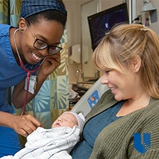Newborn with caregiver and parent