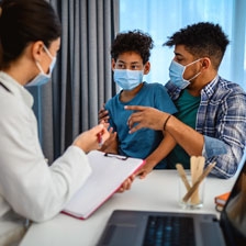 Portrait of father and son with physician