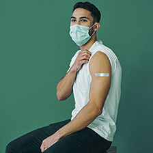 Young man showing bandage from arm shot - IG