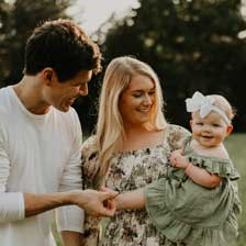 Family holding baby