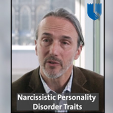 Man in coat w/ text of Naarcissistic Personality Disoder Traits under him