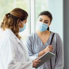 Two women talking in a clinical setting