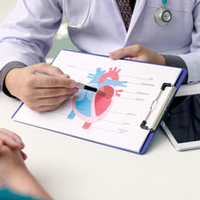Caregiver showing a heart graphic to a patient