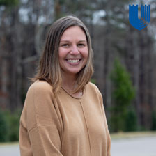 Patient smiles in front of wooded area - story about ICI eye curgery