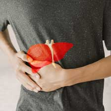 Person holding side with image of liver superimposed