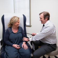 doctor taking blood pressure of patient