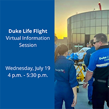 Two Duke Life Flight team members walk into Duke University Hospital. 