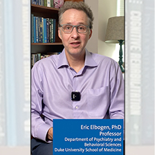 Eric Elbogen seated in front of a bookcase