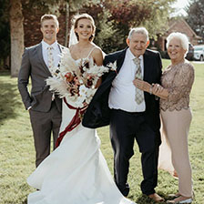 Karen Kump stands next to her husband and granddauaghter at her wedding