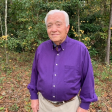 Daniel Johnson standing outside wearing a purple button down shirt