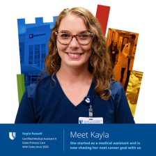 Kayla smiling in blue scrubs with colorful Duke shield in the background. 