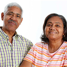 A couple smiles into the camera