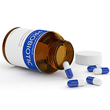Pill bottle labelled probiotic includes pills in front of bottle