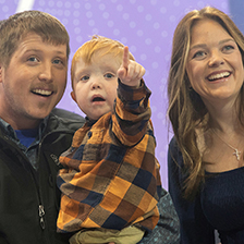 Family with child who is pointing off in the distance