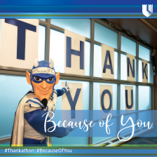The Duke Blue Devil mascot stands in front of a sign that says Thank You. 