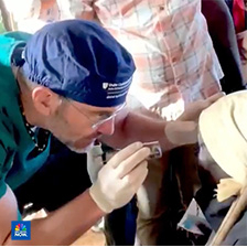 Dr. Williams examines a patient in an outdoor setting