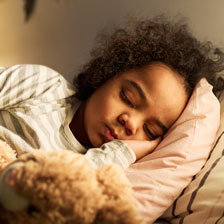a child sleeps in bed
