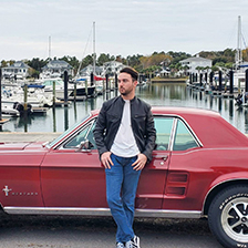 Harvey Squires leans against his red 1967 Mustang