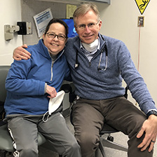 Dr. Reynolds and Weber sit next to each other and smile