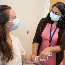 Dr. Mantri holds the hand of a patient