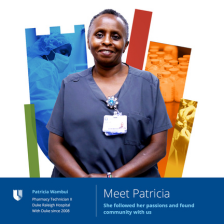 patricia wambui smiling in front of colorful shield.