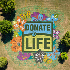 Donate Life message in flowers and paint on a lawn