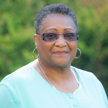 Blanchie Marston Stevenson stands outside and smiles at the camera