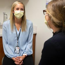The doctor speaks to her patient