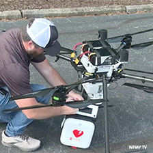 Man loads AED onto flying drone