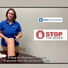 Tricia Smar demonstrats Stop the Bleed with a leg mannequin. 
