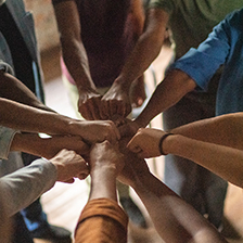 Hands fistbumping in a circle
