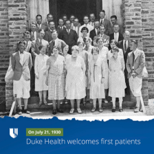 Duke University Hospital team members in front of hospital in black and white image.