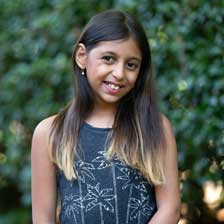 Ela Allam stands outside and smiles