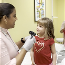 Doctor checks the ears of a child