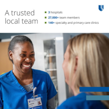 Two nurses smile at each other.