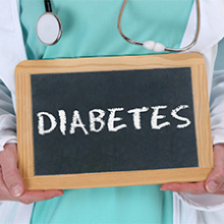 Care provider holds slate with DIABETES written on it