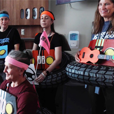 Teachers in costume sing in a patient room