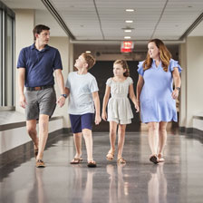 Joe McFadden walks with his family in Duke Hospital