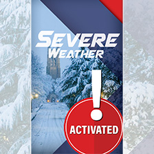 Wintery scene with the words Severe Weather and Activiated on it, over a stop sign with an exclamation point