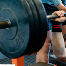 Weight lifter lifts weights on bench