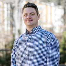 Chris Biggar stands outside his home in Durham, NC.