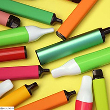 Colorful e-cigarettes scattered around a table. 