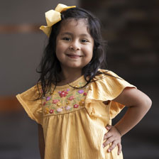 Emi smiles at the camera
