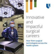 Female surgical tech smiles in scrubs and scrub hat in a Duke OR with equipment surrounding her.