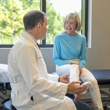 Penny sits with Dr. Murawski and he inspects her foot