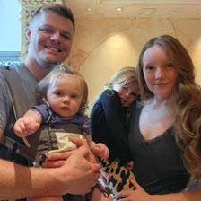 Chasity stands with her husband and two children