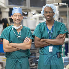 Interventional radiologist James Ronald, MD (left), and vascular surgeon Kevin Southerland, MD (right), stand in an operating room used for deep vein arterialization.