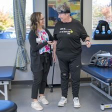Physical therapist Katie Hester, DPT, smiles at Sue Brooker, a patient at Duke Physical Therapy and Occupational Therapy Holly Springs.