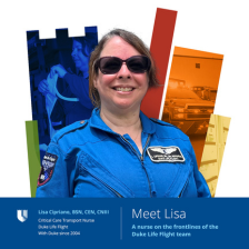 Lisa smiles in a blue Duke Life Flight jumpsuit and sunglasses. A colorful Duke Health shield is behind her.